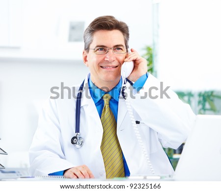 Medical doctor calling by phone at the hospital. Health care.