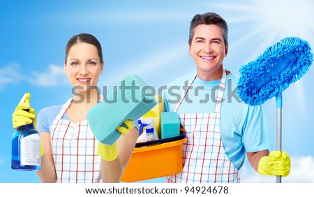 Professional cleaners team. Over blue background.