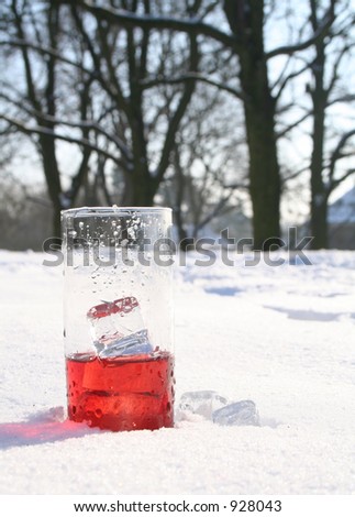 Red, icy drink standing in snow