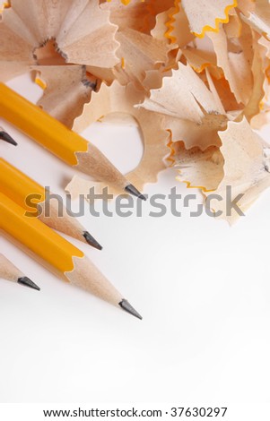 Yellow pencils and pile of pencils shavings - view from above