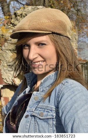 Woman outdoors , natural portrait of a girl . The cap on his head .