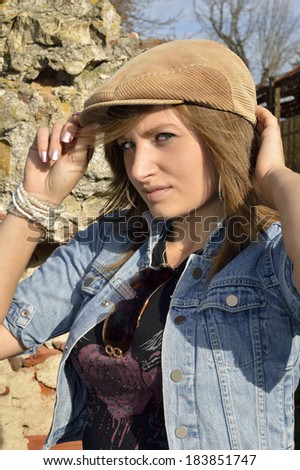 Woman outdoors , natural portrait of a girl . The cap on his head .