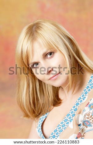 Natural portrait of attractive woman sitting on the chair