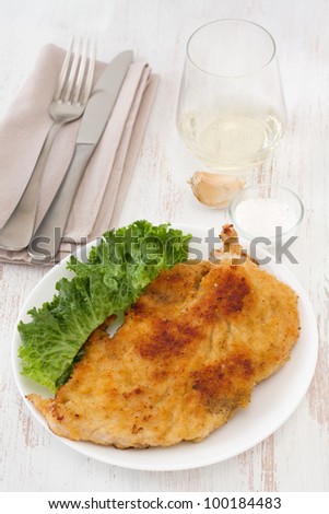 fried turkey with salad on the white plate