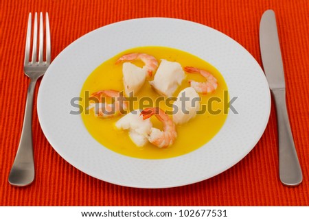 fish with shrimps in sauce on the plate