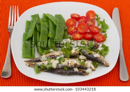 fried sardines with boiled green beans and tomato