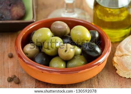 green and black olives in ceramic bowl