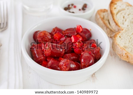 fried sausages in white bowl and bread