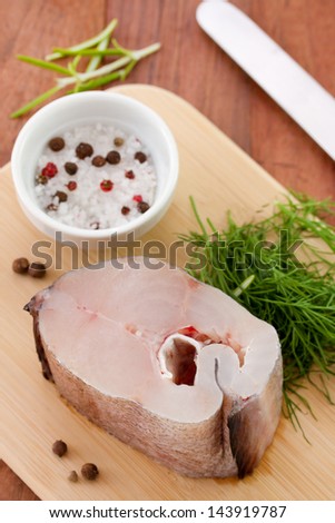 raw fish with salt and knife