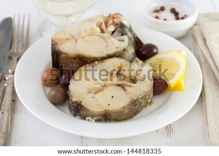 boiled fish with olives and lemon