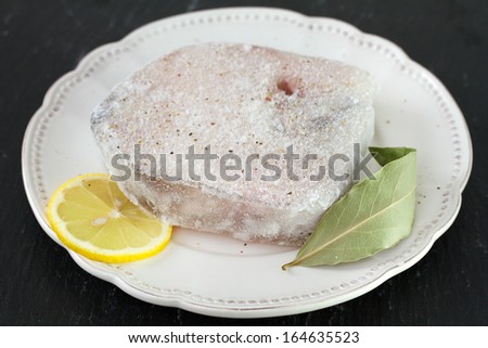 frozen fish with lemon in plate
