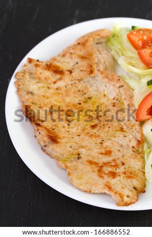 fried turkey with vegetables on plate