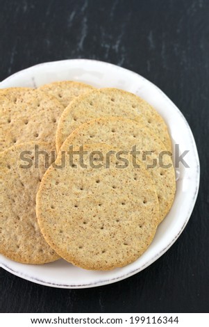 cookies on plate on black background