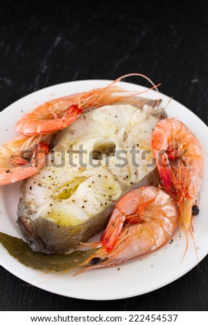 boiled fish with boiled shrimps on plate