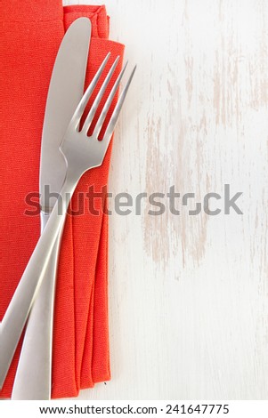 red napkin with knife and fork on white background