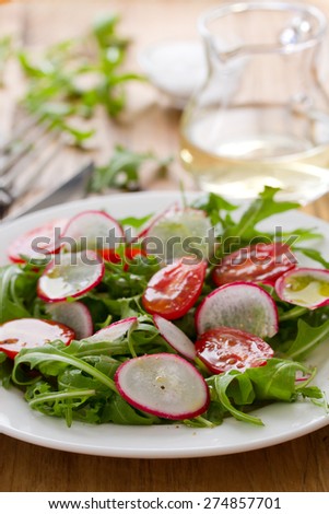 salad with radish on plate and white wine
