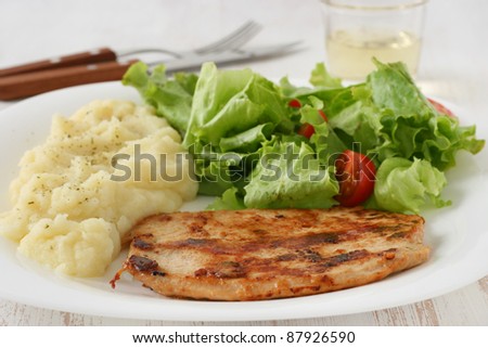 fried turkey with mashed potato and salad
