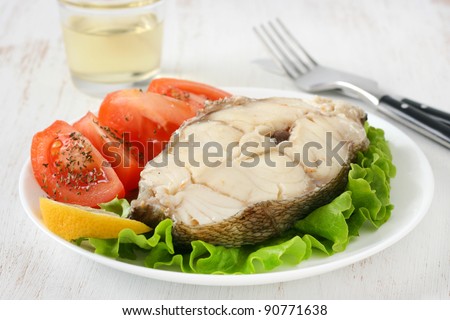 boiled fish with glass of wine
