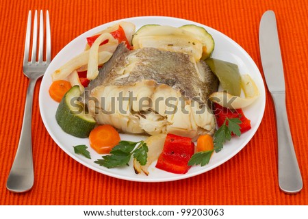 boiled fish with vegetables on the plate