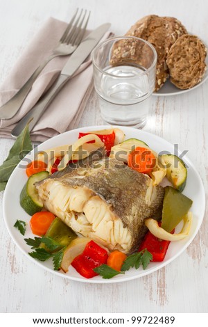 boiled fish with vegetables on the plate