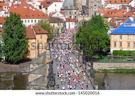 PRAGUE, CZECH REPUBLIC - MAY 12: Group of runners runs the Volkswagen Prague Marathon, May 12, 2013 in Prague, Czech republic. Runners run over the Charles Bridge, the famous place in Prague.