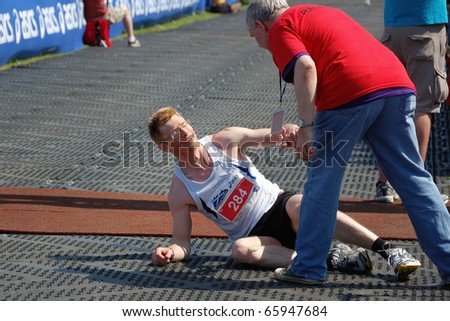 EDINBURGH, SCOTLAND, UK - MAY 23: An unidentified runner needs help after finishing the Edinburgh Marathon , May 23, 2010 in Edinburgh, UK.