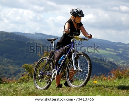 VSETIN, CZECH REPUBLIC - SEPTEMBER 9: Biker Andrea Jungwirthova climbs the hill above town of Vsetin in Wallachian 50 Mountain Bike Race, September 9, 2006 in Vsetin, Czech republic.
