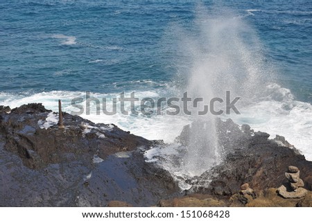 Water spouts through the Halona Blowhole, a hole in the rocks along the coast of Oahu, Hawaii