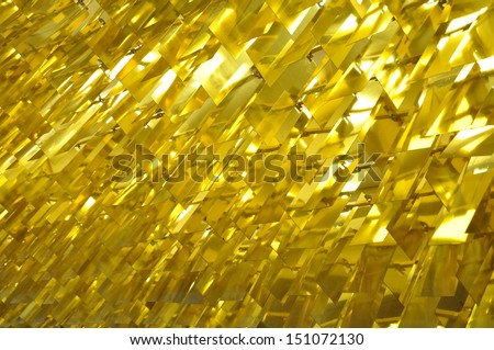 Bright lit gold decorations hanging from a ceiling