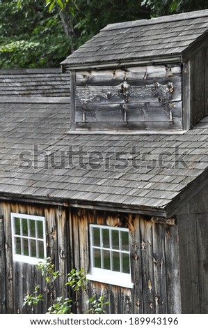 Weathered wood-shingled roof and walls of a maple sugar shack in New Hampshire
