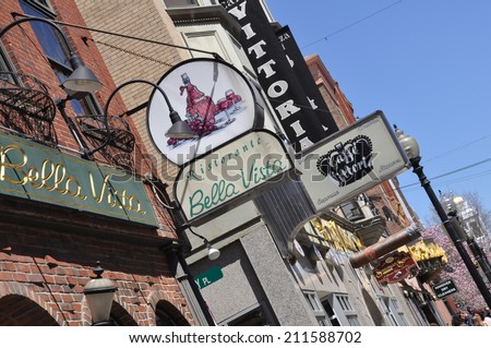 19 April - Boston, MA:  Signs for shops and restaurants line Hanover Street, the main thoroughfare of Boston\'s North End neighborhood, on the weekend of the 2014 Boston Marathon.