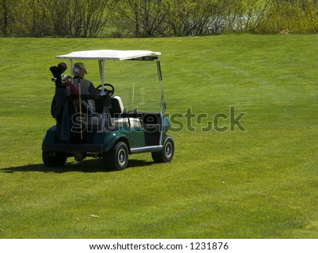 Man Sitting in Golf Cart on Golf Course Green