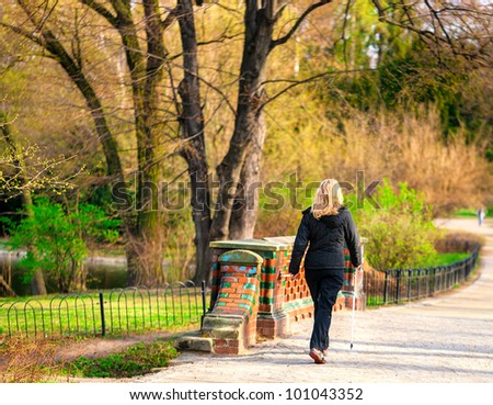 Attractive woman nordic walks in spring time