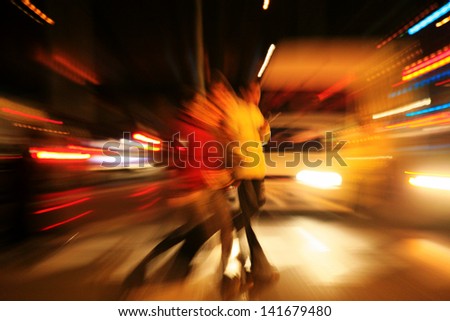 Blurred silhouettes of people in city