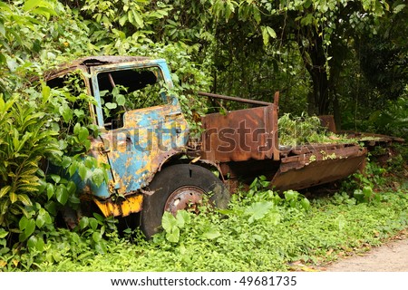 Environment issue: Vegetation eats truck wreck on St. Lucia in the Caribbean