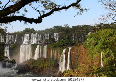 Iguassu waterfalls on a sunny day early in the morning. The biggest waterfalls on earth.