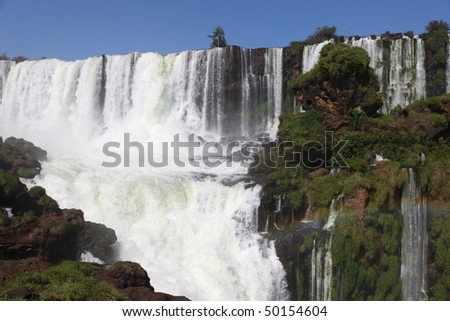 Iguassu waterfalls on a sunny day early in the morning. The biggest waterfalls on earth.