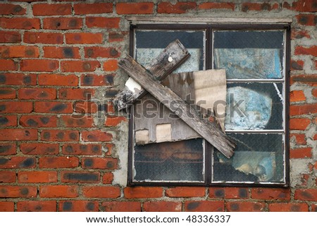 Old repaired window on brick wall