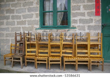 A traditional house of a Chinese family, with chairs outside