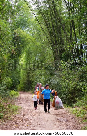 YANGSHUO, CHINA - MAY 17: Farmers are back from farmland on May 17, 2010 in Yangshuo, China