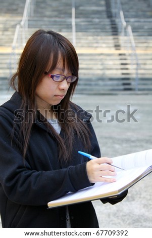 A smart Chinese girl reading in a University