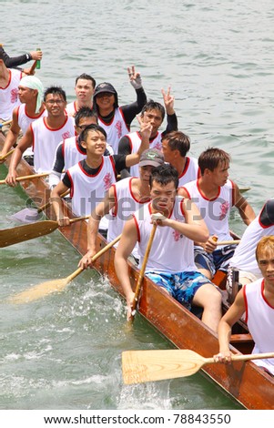 HONG KONG - JUN 6: Athletes fight hard for victory and they won at the dragon boat racing in Tuen Ng Festival June 6, 2011 in Tuen Mun, Hong Kong.