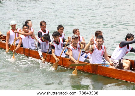 HONG KONG - JUN 6: Athletes fight hard for victory and they won at the dragon boat racing in Tuen Ng Festival June 6, 2011 in Tuen Mun, Hong Kong.