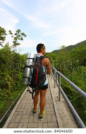 Asian man hiking on hiking trail