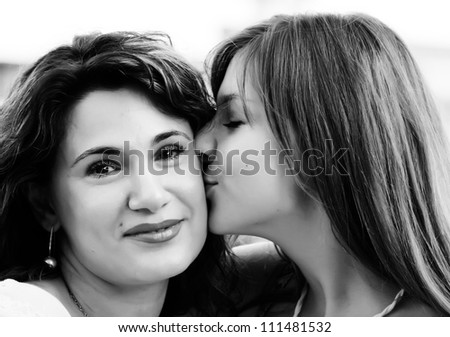 Mother and teenage daughter outside