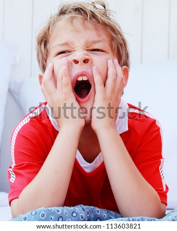a boy yawning