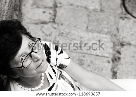 Portrait of 60-years-old beautiful woman outdoors