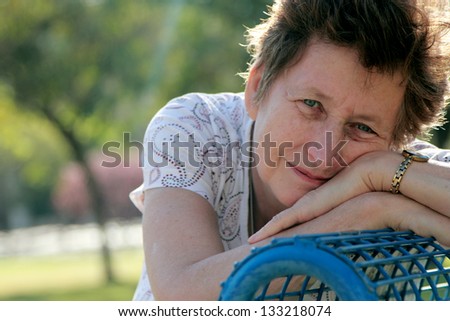 Portrait of 65-years-old beautiful woman outdoors