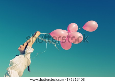 Young Redhead Woman Holding Pink Balloons