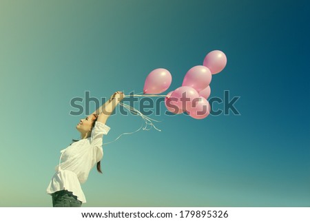 beautiful woman with colorful balloons outside